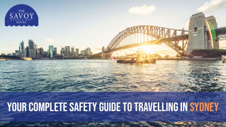 A scenic view of the Sydney Harbour Bridge and city skyline across the water with a bright sunburst