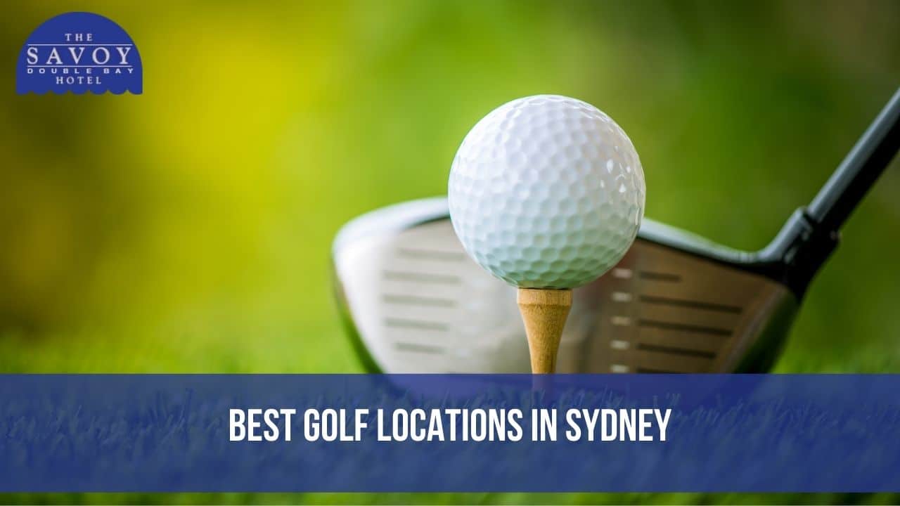 A close-up of a white golf ball sitting on a wooden tee with a golf club positioned behind it.
