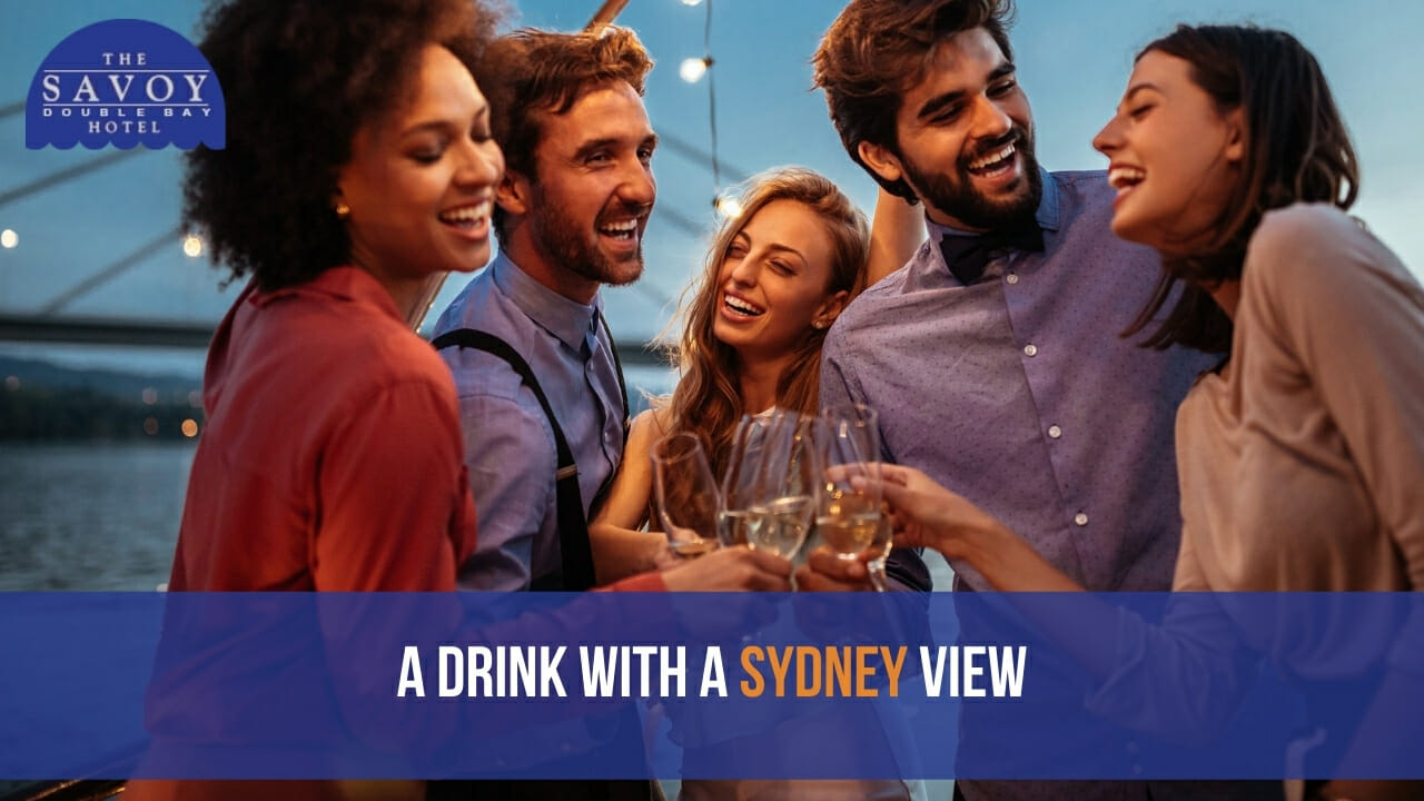 A group of friends laughing together while making a champagne toast on a boat at dusk, with a bridge structure softly lit in the background.