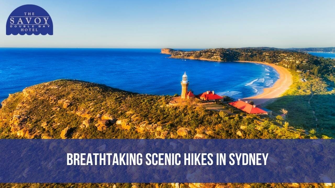 An aerial view of the historic Barrenjoey Lighthouse on a lush headland overlooking Palm Beach and the blue ocean