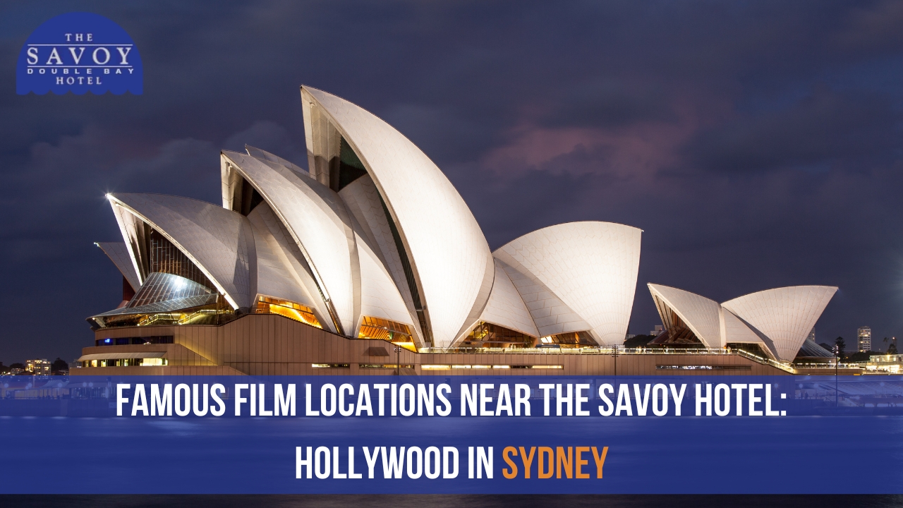 A night view of the illuminated Sydney Opera House under a dark cloudy sky.