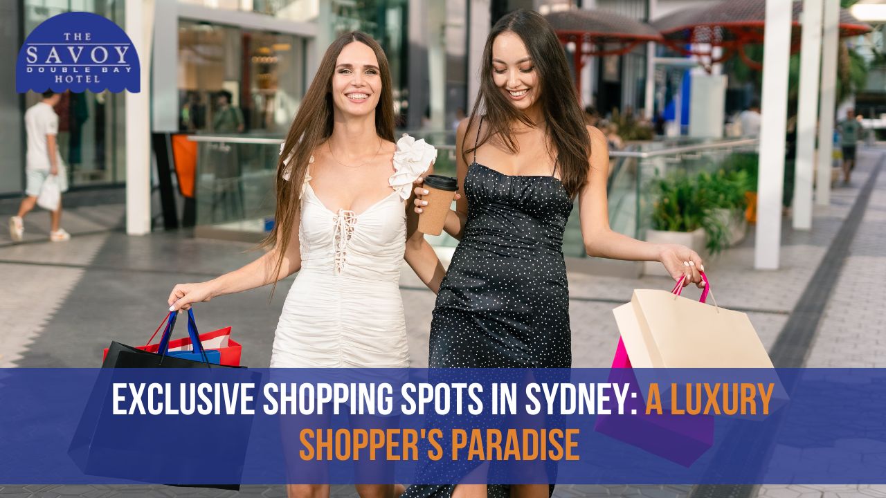 Two smiling women walking through an upscale outdoor shopping plaza while carrying shopping bags and a coffee cup