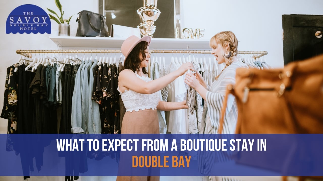 Two young women looking at clothes together on a hanger in a boutique shop.