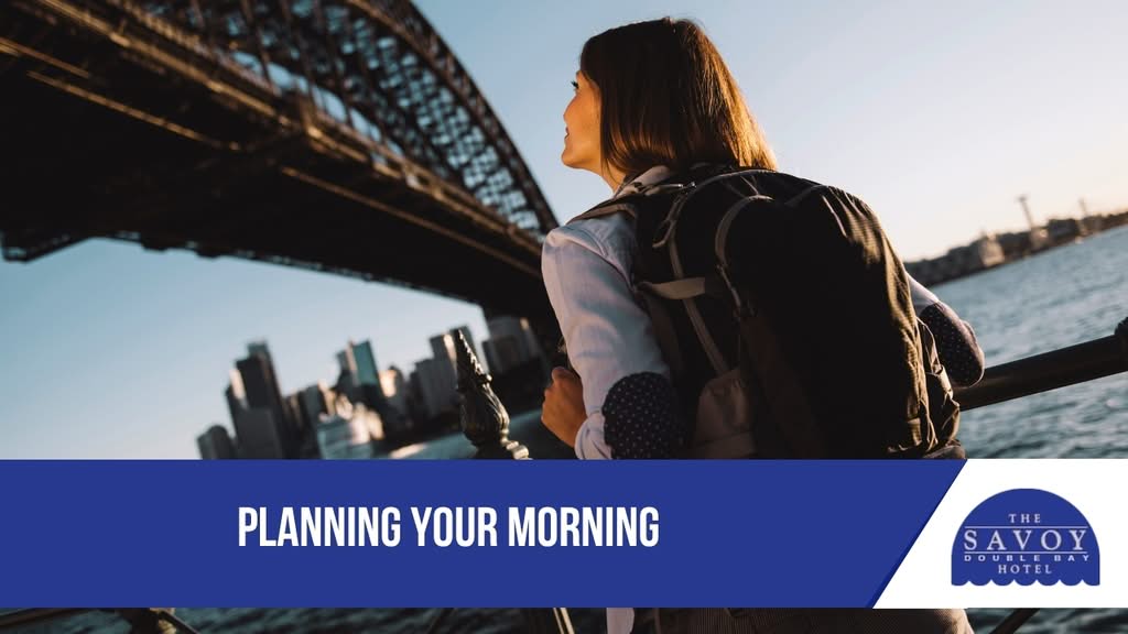 Top 10 Sydney Bayside Walks and Cafés Near Double Bay - Double Bay A woman with a backpack looking up at the Sydney Harbour Bridge from the harbor foreshore near Double Bay