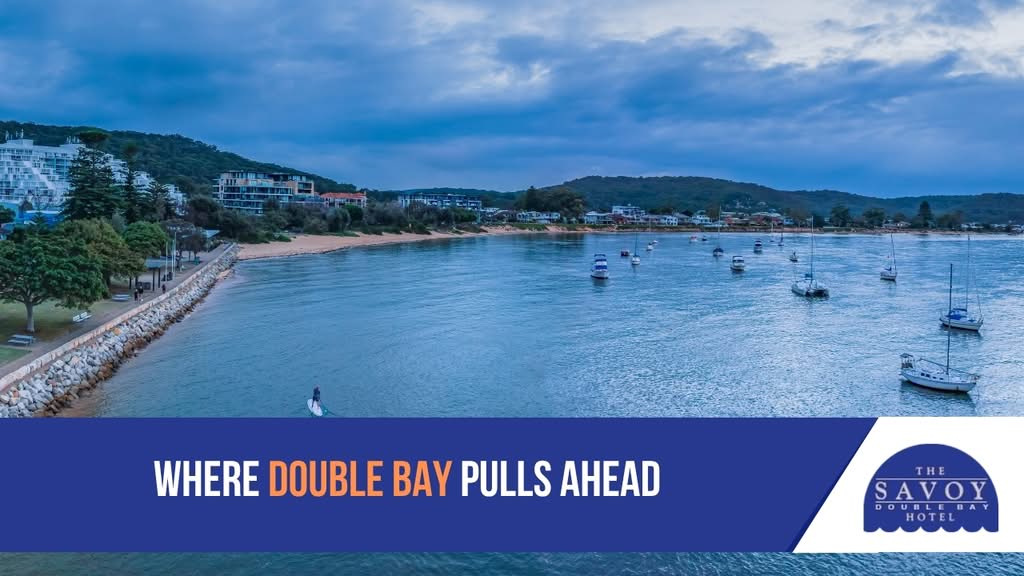 Explore Sydney's Hidden Coastal Suburbs: Why Double Bay Tops the List - Double Bay An aerial view of Double Bay shoreline with boats anchored in the calm harbor water and coastal buildings in the background.